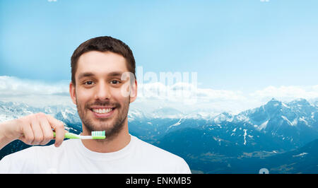 smiling young man with toothbrush Stock Photo