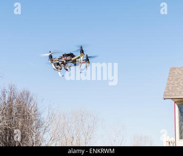 A home built Do It Yourself quad copter drone, flying. Stock Photo