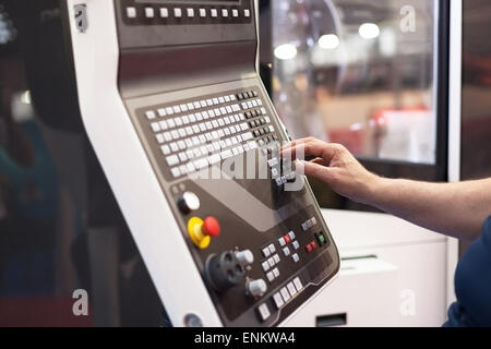 hand on the control panel of a programmable machine Stock Photo