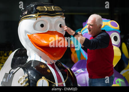 Liverpool, Merseyside, UK  7th May, 2015 Mr Barry Cole Managing Director of Aquaducked  Ltd painting Porta Duck Giggles Charity Ducks execute perfect landing on Mann island Development for Riverside Festival. A team of artists is decorating a host of giant ducks, themed on the city's history, in public view at Mann Island Development. The Liverpool Duck Trail, commissioned by AquaDucked, is to be launched on LightNight to showcase the vibrant creativity alive in Liverpool as well as to raise money and awareness for Macmillan Cancer Support. Credit:  Cernan Elias/Alamy Live News Stock Photo