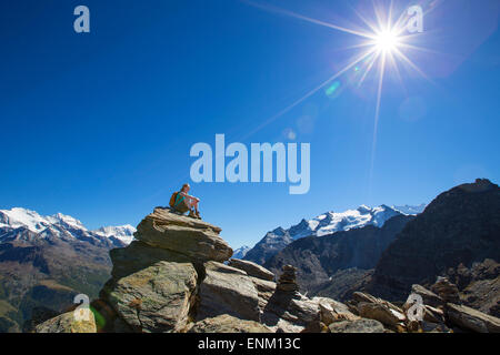 A female hiker on top of the Wannihorn in the Swiss Alps. Stock Photo