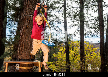 A young girl on a backyard zip line in Durango, Colorado. Stock Photo