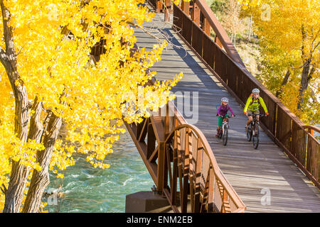 A mother and daughter mountain biking on the Animas River Trail in Durango, Colorado.