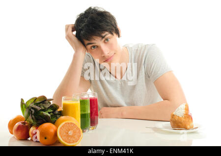 Man choosing between fruits, smoothie,salad and organic healthy food against sweets, sugar, lots of candies Stock Photo