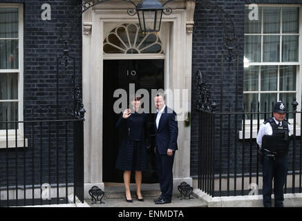 London, UK. 8th May, 2015. British Prime Minister and leader of the Conservative Party David Cameron (C) returns to No. 10 Downing Street in London May 8, 2015. The Conservative Party remained the largest party at the House of Commons after the general election held on Thursday. Stock Photo
