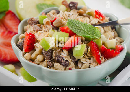Healthy muesli and fresh fruits for breakfast in a bowl. Selective focus Stock Photo