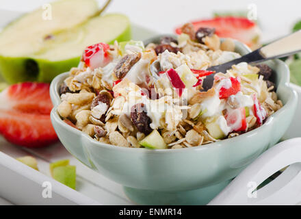 Muesli, yogurt and fresh fruits for breakfast in a bowl. Selective focus Stock Photo