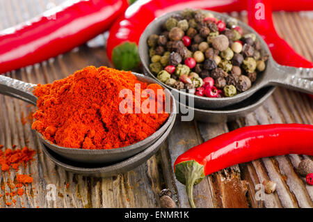 Black  and red  peppers on a wooden table. Selective focus Stock Photo
