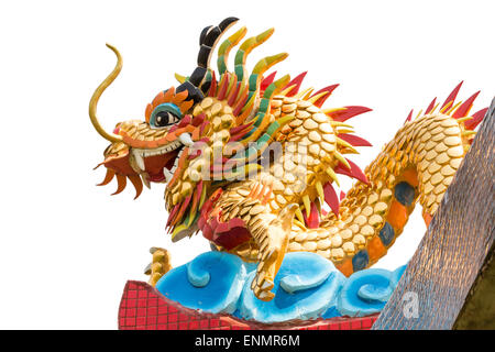 Dragon statue on temple roof on isolated background Stock Photo