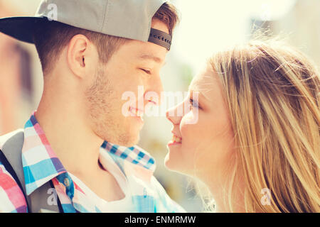 smiling couple with backpack in city Stock Photo