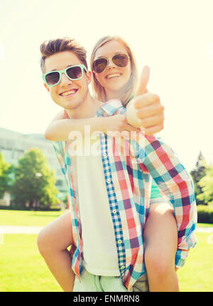 smiling couple having fun and showing thumbs up Stock Photo