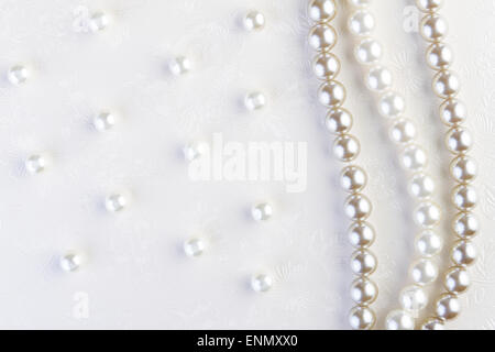 White pearls necklace on white paper background Stock Photo