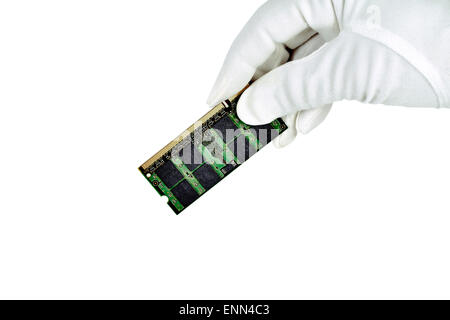 A computer memory chip held by white gloved hand isolated on white Stock Photo
