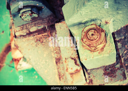 Old rusted industrial details, nuts and bolt, selective focus, shallow DOF, vintage toned photo with old style filter effect Stock Photo