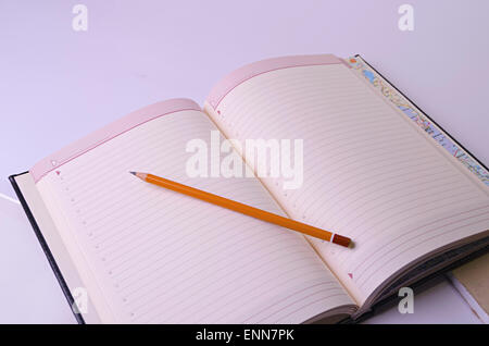 Open diary and graphite pencil Stock Photo