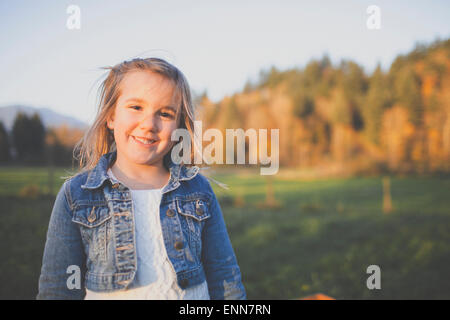 Portrait of a young girl wearing a jean jacket. Stock Photo