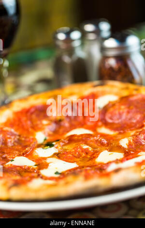 Napolitana Style Pizza on the table in Italian restaurant. Stock Photo