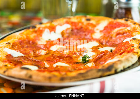 Napolitana Style Pizza on the table in Italian restaurant. Stock Photo