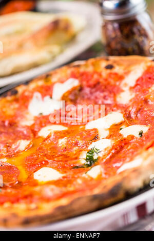 Napolitana Style Pizza on the table in Italian restaurant. Stock Photo