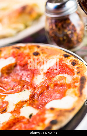 Napolitana Style Pizza on the table in Italian restaurant. Stock Photo