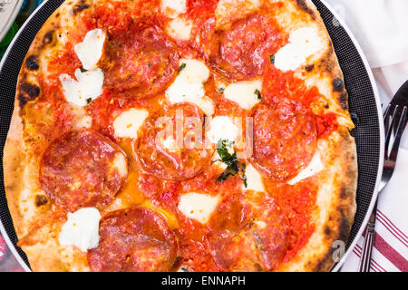 Napolitana Style Pizza on the table in Italian restaurant. Stock Photo