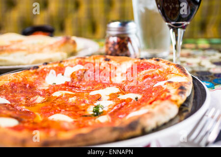 Napolitana Style Pizza on the table in Italian restaurant. Stock Photo