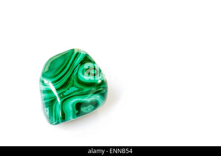 Polished malachite stone close up with reflection on white background Stock Photo