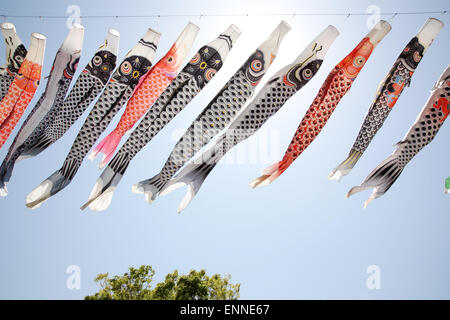Japanese carp kite streamer decoration on against blue sky Stock Photo