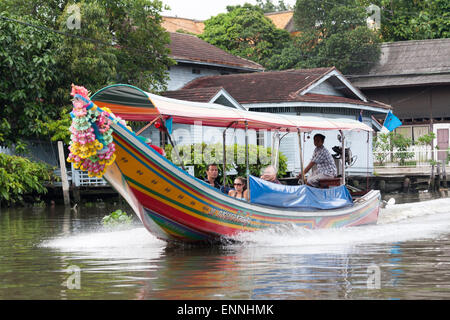 Bangkok, Thailand-August 29th 2009: A boat speeds through a khlong. A boat trip through the khlongs is a popular tourist activit Stock Photo