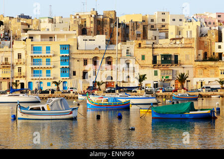The view on traditional Maltese boats in sunset, Kalkara, Malta Stock Photo