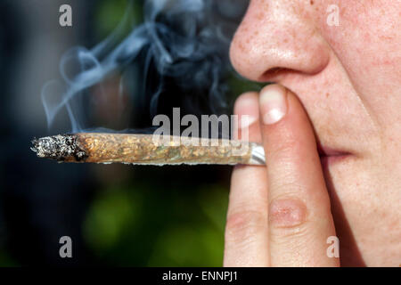 Close up, man smoking marijuana joint Stock Photo