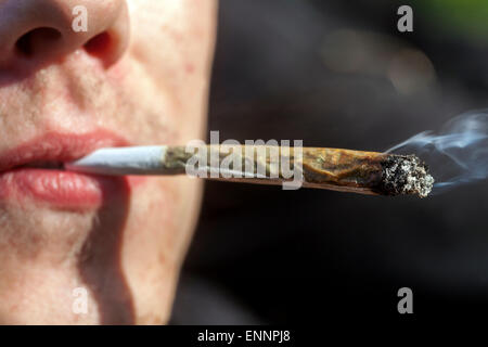 Close up, man smoking marijuana joint Stock Photo