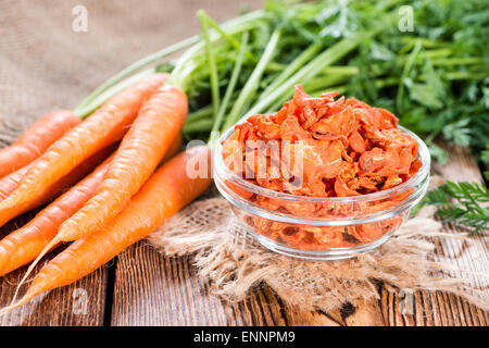 Portion of Dried Carrots (close-up shot) on wooden background Stock Photo