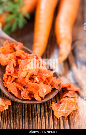 Portion of Dried Carrots (close-up shot) on wooden background Stock Photo