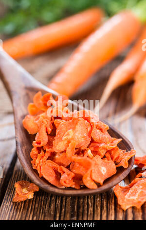 Portion of Dried Carrots (close-up shot) on wooden background Stock Photo