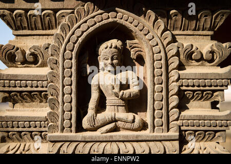 Detail of wood carving of deity on Hindu temple in Bhaktapur, Nepal Stock Photo