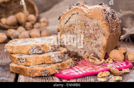 Portion of fresh baked Walnut Bread on dark wooden background Stock Photo