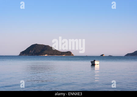 Lonely traditional greek fishing boat on sea water, Zakynthos island, Greece Stock Photo