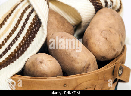 Potatoes in a Basket isolated on a white background. Stock Photo