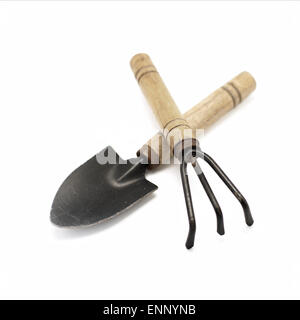 old gardening tools spade and rake isolated on white background Stock Photo