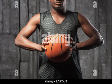 Afro-american basketball athlete gripping the ball Stock Photo