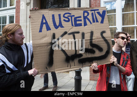 London, UK. 9 May 2015. Pictured: Protesters outside the Tory General Election campaign offices in Matthew Parker Street with an Austerity Kills placard. Several hundred protesters gathered in Westminster and marched through Central London two days after the 2015 General Election in protest of the new David Cameron/Conservative Party Government and more cuts to welfare. Photo: Nick Savage/Alamy Live News Stock Photo