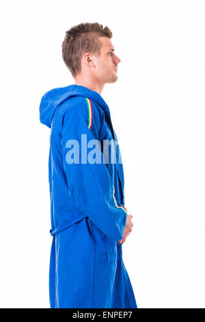 Handsome young man wearing blue bathrobe, isolated on white background Stock Photo