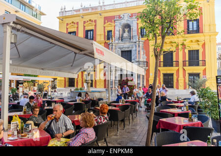 Malaga, Spain. Malaga, Spain. People sitting at a terrace by the Bishop's Palace (Palacio Episcopal) at Bishop Square (Plaza del Stock Photo