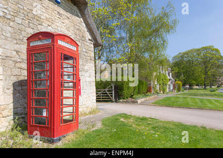 Red K6 Telephone Box in a rural village, England, UK Stock Photo