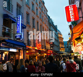 Crowds on Rue de la Huchette at dusk. Stock Photo