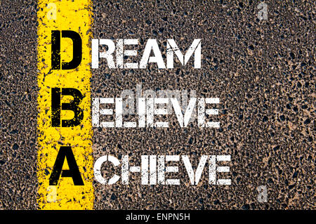 Dream, Believe, Achieve motivational quote. Yellow paint line on the road against asphalt background. Concept image Stock Photo