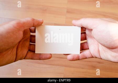 Man hands hold note with wood table office background Stock Photo