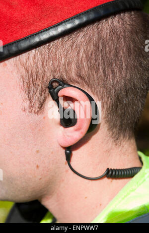 Ear piece radio communication headset signal British army soldier Royal Military Police worn by Redcap Military MP policeman UK Stock Photo