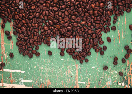 Roasted brown coffee beans on rustic grunge wood plank board background Stock Photo